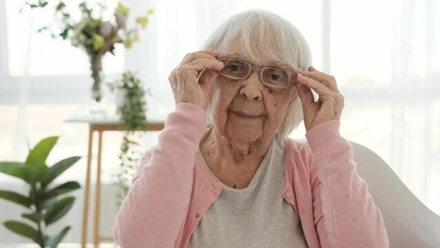 Senior woman wearing eye glasses for sight at home. Elderly female person with spectacles indoor