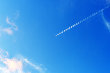 スカイブルーの空と飛行機雲