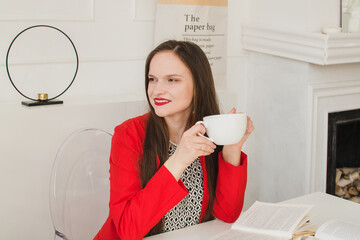 Girl in the office with a cup of coffee or tea