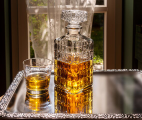 Whiskey in decorated crystal glass bottle, whiskey or bourbon in vintage bottle with glass on...