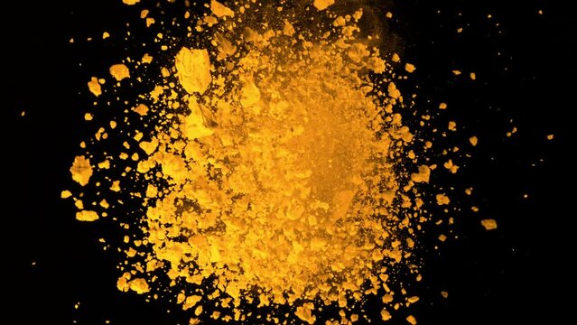 Super Slow Motion Shot of Rotating Yellow Powder Expolosion Isolated on Black Background at 1000fps.