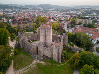 Aerial views of Guimaraes Castle. Cityscape seen from the air at sunset