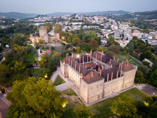 Aerial views of Palace of duques of Braganca in Guimaraes, Portugal. Cityscape seen from the air at sunset.