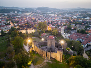Obraz premium Aerial views of Guimaraes Castle. Cityscape seen from the air at sunset