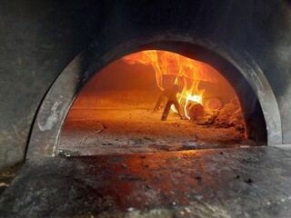 Pizza oven with burning woods