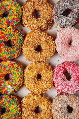 Collection of many colored donuts side by side