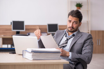 Young male employee working in the office