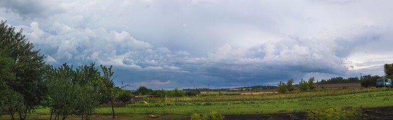 Summer cloudy country landscape before thunderstorm