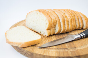 sliced bread and a knife on a white background. White bread slices