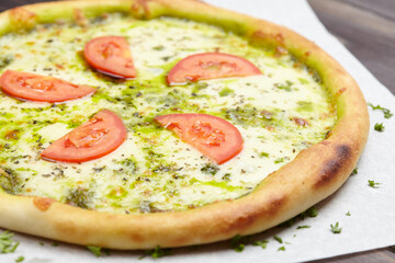 tasty pizza on the wooden background