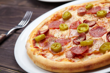 tasty pizza on the wooden background