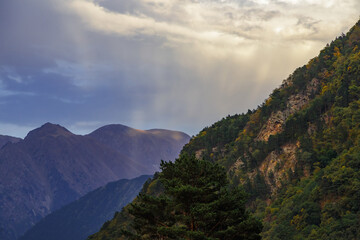 Sunset in the mountains. Rays fall on the mountains.