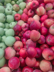 juicy fresh red and green apples of the new harvest on the supermarket counter