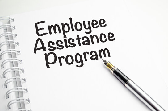 EAP Employee Assistance Program - word on a white notebook against the background