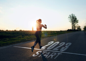 Sporty girl who runs towards year 2023. New year 2023 with new ambitions, plans, goals and visions. 
