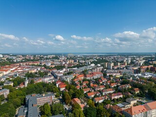 Bird's eye view of the cityscape of Szczecin in Poland under a cloudy blue sky
