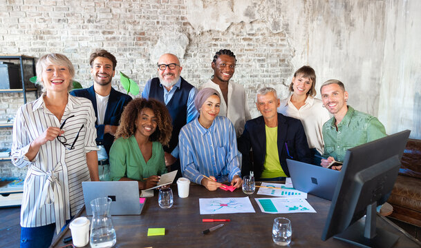 Portrait of a smiling group of multiracial corporate colleagues in a vintage office