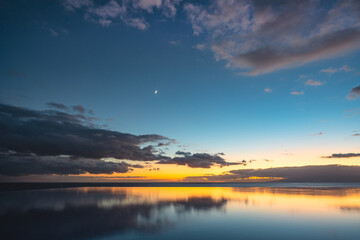 Reflection of the ocean sunset in the pool