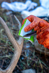 Hunter with a Wyoming resident hunting license tag for deer - shallow depth of field, selective...