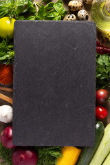 Variety of fresh vegetables slate stone at table background. Cooking concept and salad ingredients