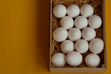 Special box with straw for reliable delivery of chicken white eggs. Store eggs in one basket. Fresh eggs for breakfast.