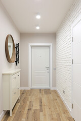 White entrance door inside an apartment interior