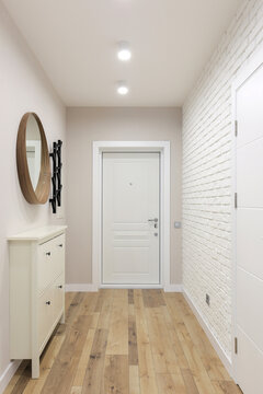 White entrance door inside an apartment interior