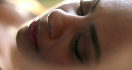 Fototapeta premium Woman opening eyes and looking up at camera in dreamy mood