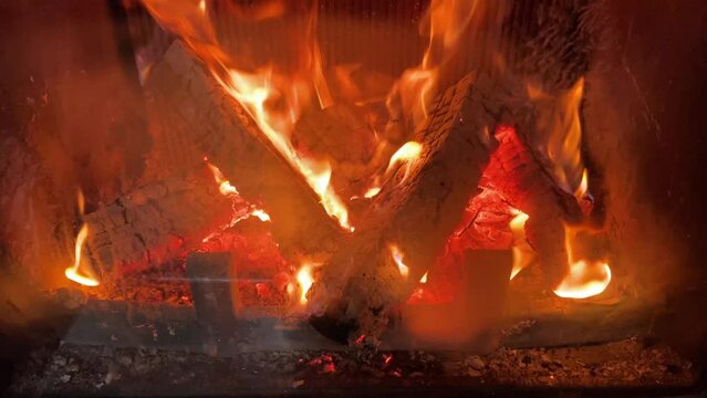 Fire in the fireplace. View of the fireplace when the firewood is burning. Comfort in home.фильм