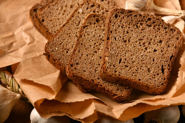 still life of food in a rural style on a dark wood background, rye bread and garlic, concept of fresh vegetables and healthy food