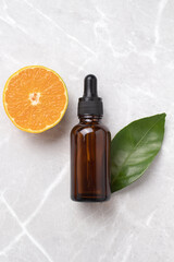 Bottle of orange essential oil for skin face and body health care. Hyaluronic acid oil, serum with collagen and peptides skin care product.