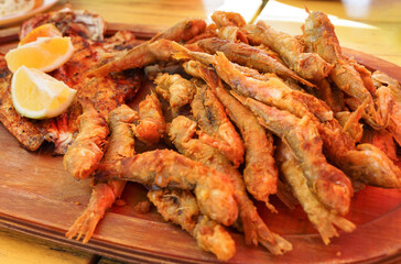 Plate of fried small fish red mullet and lemon