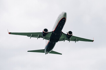 Passenger plane comes in for landing in cloudy weather.