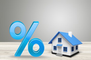 Colored percent symbol and toy house on the desk