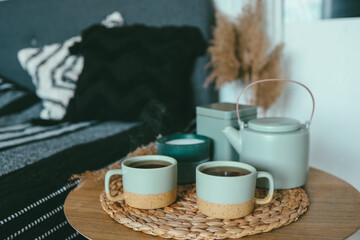 Bedroom decorative objects on the bed in cozy vintage bedroom. Two cups of tea and a ceramic teapot. Home decoration concept