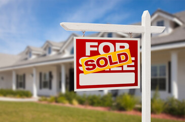 Sold Real Estate Sign in Front of Beautiful House