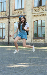 Fototapeta na wymiar happy denim girl with backpack jumping outdoor