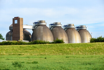 Large steel tanks in a wastewater treatment plant at sunset