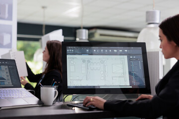 Real estate agent working in floor planner software, blueprints, home interior wireframes on...