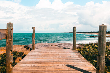 Fototapeta na wymiar Peacefull wooden bridge on the coast with nice views from Puerto Rico Piñones la posita beach 