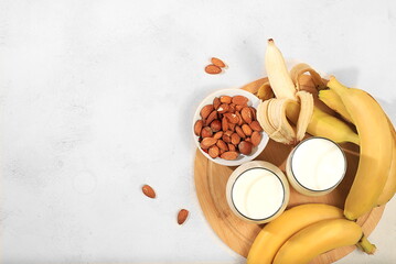 Assortment of vegan non-dairy products. Banana and nut vegan alternative milk lactose and gluten free, allergy free, healthy eating concept, maintaining a healthy gut microflora,