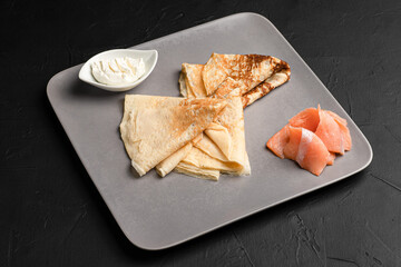 Pancakes, pancakes with different fillings on a black background