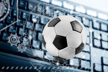 football or soccer ball with infographic on keyboard
