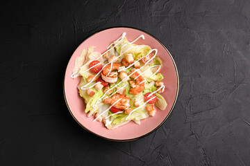Caesar salad, fresh caesar salad with crackers on a black background