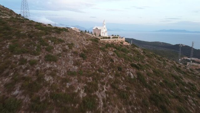 Beautiful view of an old church on a green hill in Dhermi, Albania