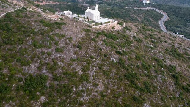 Beautiful view of an old church on a green hill in Dhermi, Albania