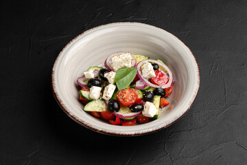 Greek salad, fresh Greek salad and on a black background