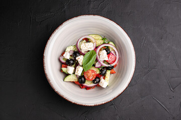 Greek salad, fresh Greek salad and on a black background