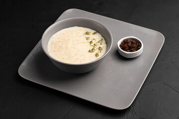 Porridge, porridge with berries for breakfast on a black background