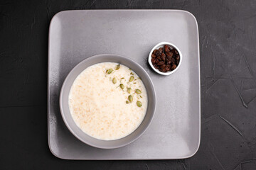 Porridge, porridge with berries for breakfast on a black background